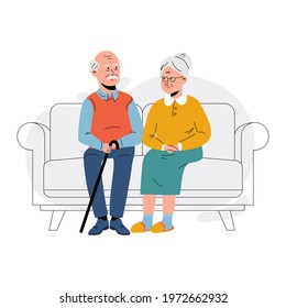 Elderly couple sitting on the sofa at home. Retired elderly couple in love. Grandparents family, grandmother and grandfather happy friends sitting on the couch 