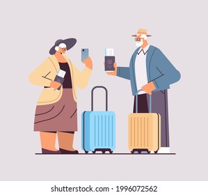 elderly couple of tourists grandparents with luggage passports and tickets ready to boarding at airport vacation