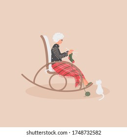 Elderly cute woman is sitting in a rocking chair.Old lady covered her feet with checked woollen plaid.Cartoon granny is knitting a sock in a comfortable rocker.White cat sit next.Vector illustration