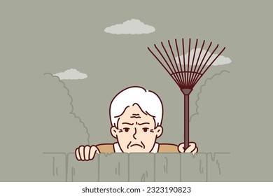 Elderly envious man neighbor peeps from behind fence spying on residents of private house. Envious male pensioner with rake looking at screen suspiciously for bad neighborhood concept.