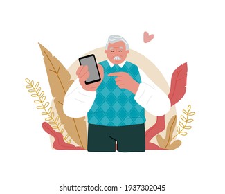 An elderly grandfather is holding a cell phone.Senior people using smart devices.He smiles and points his finger at it. 