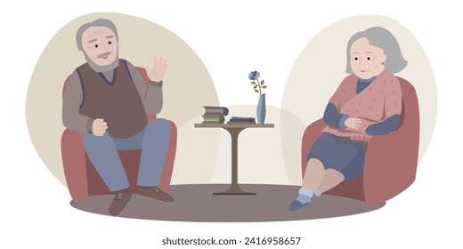 An elderly husband and wife are sitting in chairs opposite each other. The old man talks. The old woman listens and warms herself, wrapped in a shawl. Between them is a table with books and a vase.