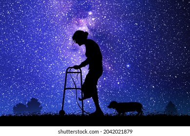 Elderly lady and dog. Old woman with walker at starry night. Milky Way