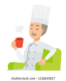 An elderly male chef wearing a cook coat is sitting on a sofa and drinking coffee