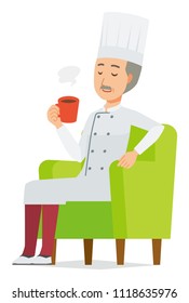 An elderly male chef wearing a cook coat is sitting on a sofa and drinking coffee