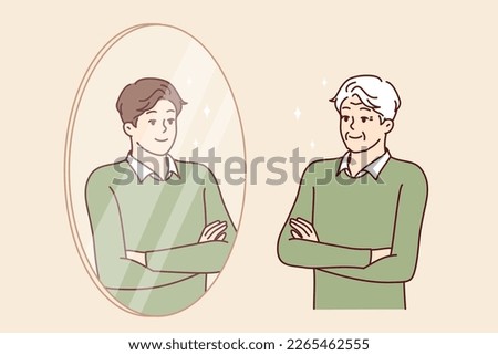 Elderly man stands in front of mirror and sees himself as young guy feeling surge of energy. Young guy looks at grandfather who looks like grandson or son for concept of generational heredity 