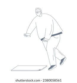  An elderly man trips on a mat and falls.