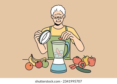 Elderly man uses blender and prepares smoothies from fresh fruits and vegetables in order to stay healthy. Retired man prepares smoothies and follows vitamin diet prescribed by nutritionist doctor