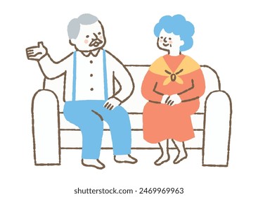 Elderly man and woman sitting on couch at home talking_Color