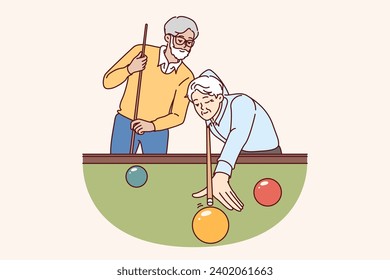 Elderly men play billiards, enjoying favorite hobby that allows them to relax and spend time with friends after retirement. Male pensioners stand near billiards table, competing in american pool