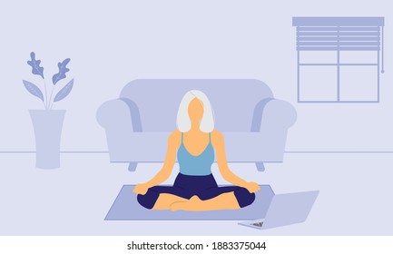 Elderly woman doing online yoga class at home