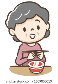 Elderly woman eating cup ramen