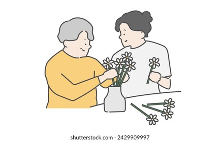 Elderly woman and female caregiver enjoying recreation (fresh flowers, flower arrangement)