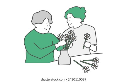 Elderly woman and female caregiver enjoying recreation (fresh flowers, flower arrangement)