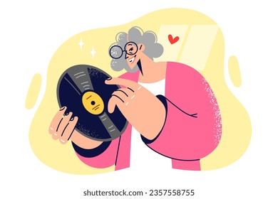 Elderly woman holds vinyl record for listening to music on gramophone and collects rare sound recordings. Grandmother collector with vinyl record in hands, rejoice at new find from last century