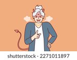 Elderly woman with horns and devil tail screams and points with finger, scolding and threatening opponent. Gray-haired woman pensioner in image of devil feels hatred for concept of senile aggression