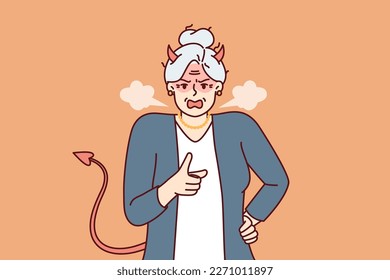 Elderly woman with horns and devil tail screams and points with finger, scolding and threatening opponent. Gray-haired woman pensioner in image of devil feels hatred for concept of senile aggression