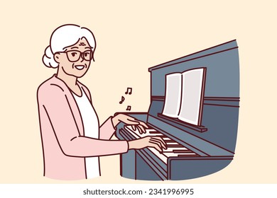 Elderly woman plays piano and smiles, rejoicing at presence of creative hobby. Happy grandmother sitting near pianoforte or piano and doing tutoring and learning to play musical instruments