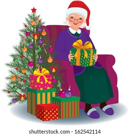 Elderly woman sitting in a chair with Christmas present in hands