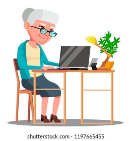 Elderly Woman Sitting At Table And Working With Laptop Vector. Isolated Illustration
