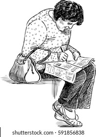  Elderly woman solves a crossword puzzle on a park bench