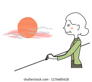  Elderly woman standing on balcony and watching sunset or sunrise thoughtfully. Pensive woman looking out and watching twilight sky until dusk.