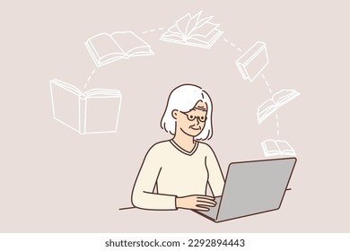 Elderly woman uses laptop to read e-books or watch useful lecture to gain new knowledge. Elderly lady is sitting at table with laptop studying computer literacy and reading useful books or fiction 