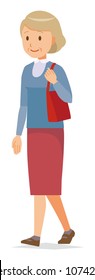 An elderly woman wearing blue clothes is walking with a bag