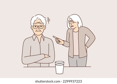 Elderly woman yells at man suffering from alcohol addiction and drinking vodka from glass. Gray-haired pensioner with elderly wife quarreling over alcohol problems or social disadvantage