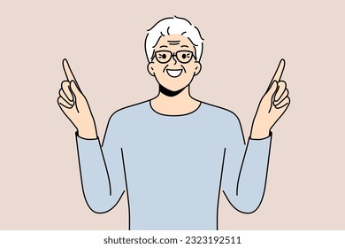 Eldery man came up with idea and points fingers up with smile to draw attention to your ad. Gray-haired pensioner in glasses recommends paying attention to good offer or cool idea.