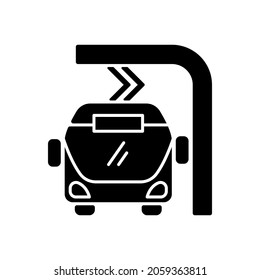 Electric bus en route charging black glyph icon. Filling up battery of tourism bus. Ecological traveling ideas. Eco transportation. Silhouette symbol on white space. Vector isolated illustration
