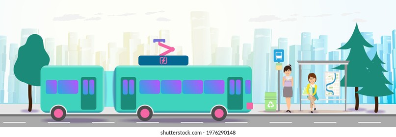 An electric bus pulls up to a stop with people in the background of the city