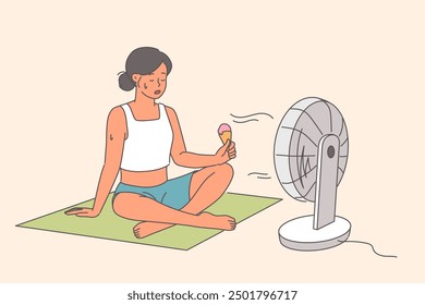 Electric fan blows on woman eating ice cream, sitting on floor in hot weather during summer season. Sweaty girl suffered heat stroke tries to cool down with electric fan and cold dessert.