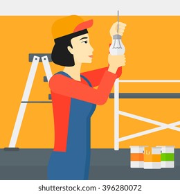 Electrician twisting light bulb.