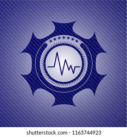 electrocardiogram icon inside badge with denim background