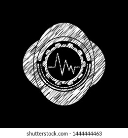 electrocardiogram icon inside chalk emblem written on a blackboard