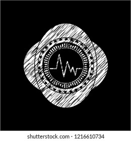 electrocardiogram icon inside chalkboard emblem on black board