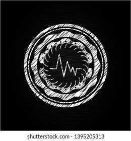 electrocardiogram icon inside chalkboard emblem on black board