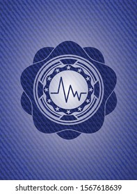 electrocardiogram icon inside emblem with jean background
