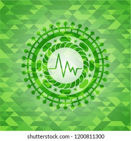electrocardiogram icon inside green emblem with mosaic background