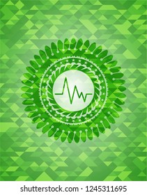 electrocardiogram icon inside green emblem with mosaic ecological style background