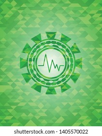 electrocardiogram icon inside green emblem with mosaic background
