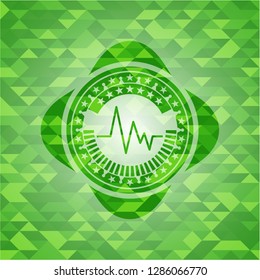 electrocardiogram icon inside green mosaic emblem