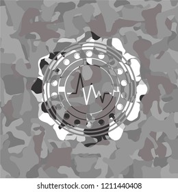 electrocardiogram icon inside grey camouflage texture