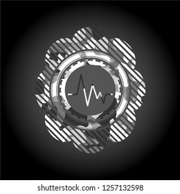 electrocardiogram icon inside grey camouflaged emblem