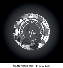 electrocardiogram icon inside grey camouflaged emblem