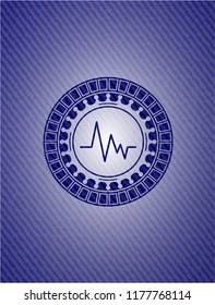 electrocardiogram icon inside jean or denim emblem or badge background