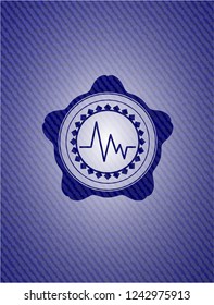 electrocardiogram icon inside jean or denim emblem or badge background