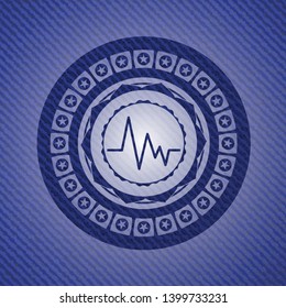 electrocardiogram icon inside jean or denim emblem or badge background