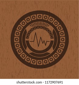 electrocardiogram icon inside realistic wood emblem